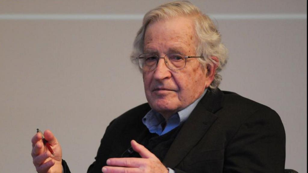 Linguist Noam Chomsky gestures with his hands as he speaks at the British Library in 2013.