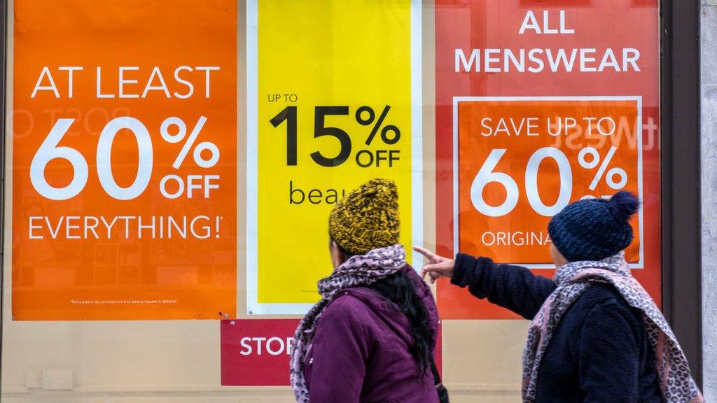 Shoppers outside a Debenhams store