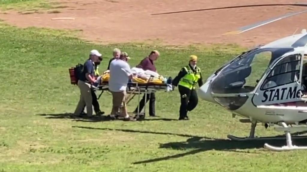 Salman Rushdie being taken to a helicopter following his attack