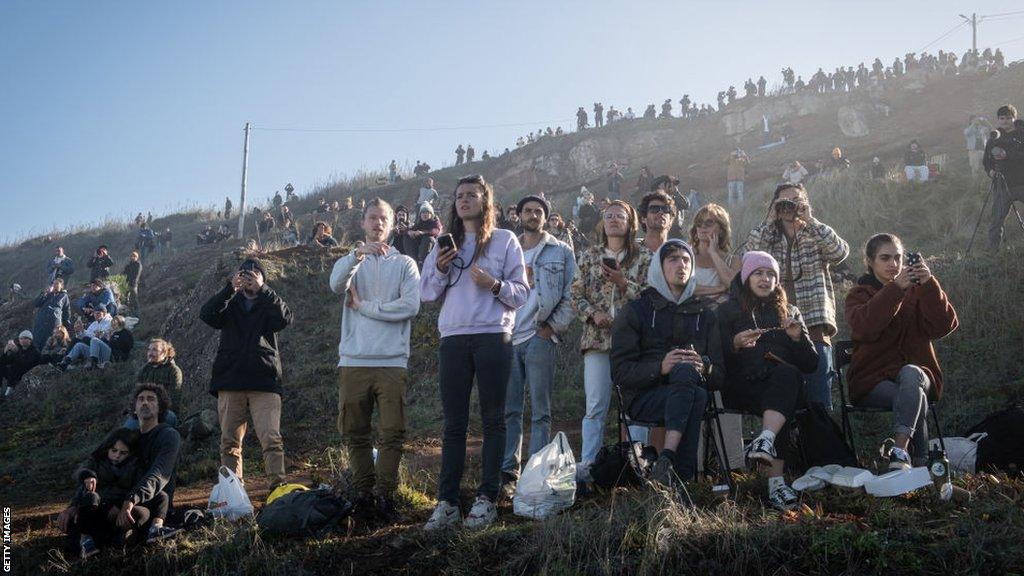 Crowd gather at Nazare