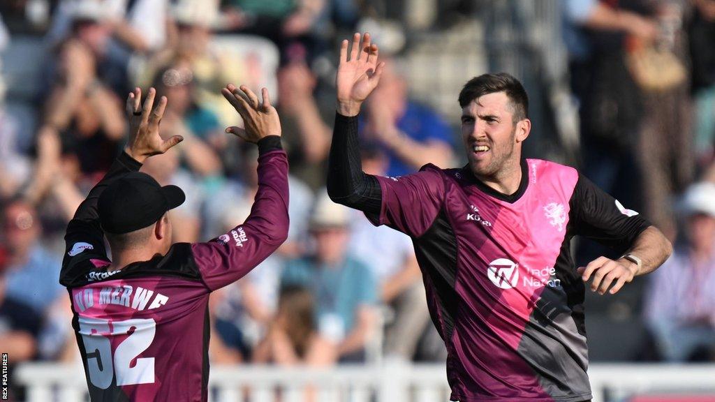 Craig Overton celebrates taking a wicket