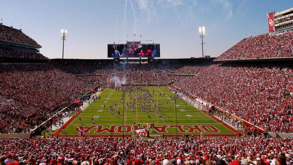 Oklahoma fans cheer as the team runs on to the field for a game against Arkansas State