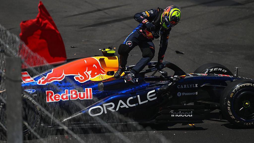 Isack Hadjar climbs out of his Red Bull after crashing in Monaco Grand Prix first practice