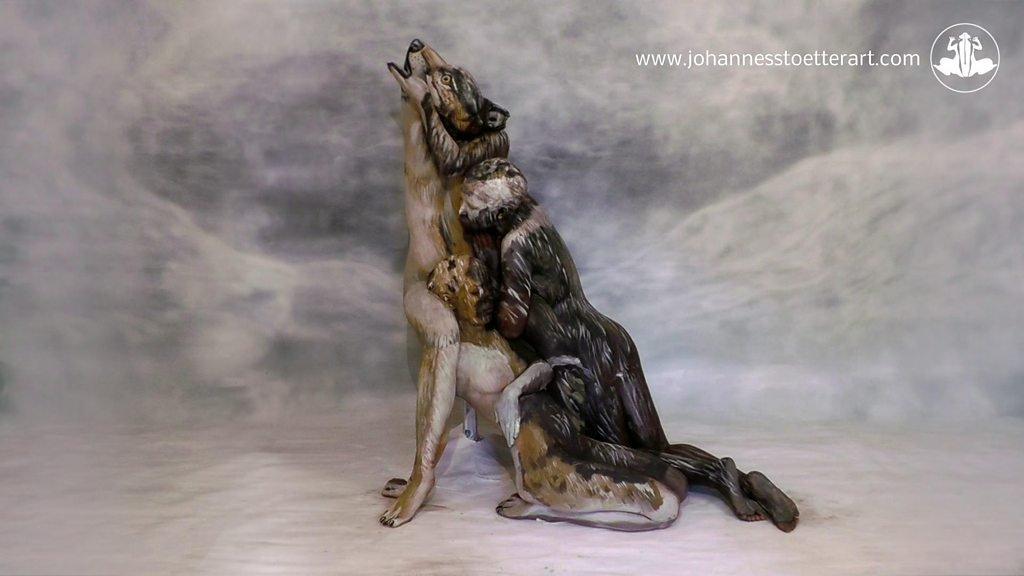 Illusion of a wolf created from bodypainted humans.