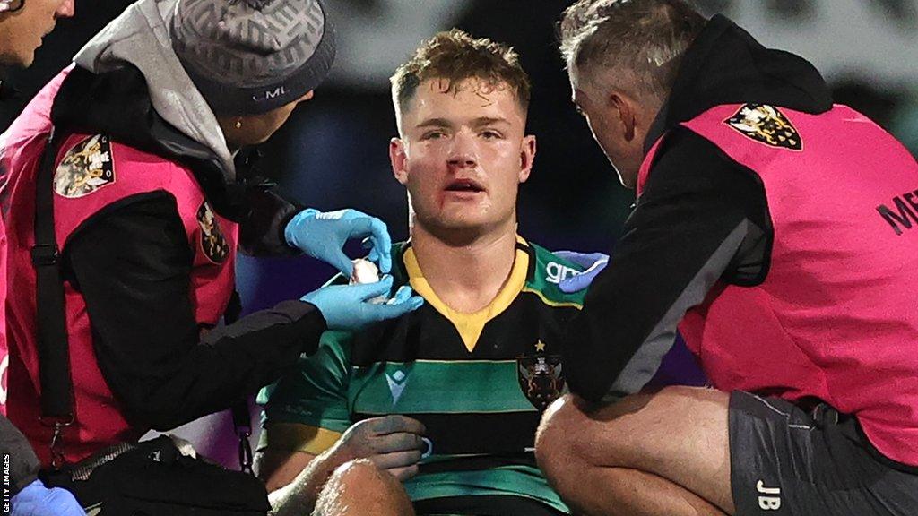 Northampton's Fin Smith after being kicked by Niall Armstrong