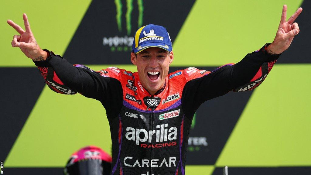 Aprilia Racing's Aleix Espargaro celebrates on the podium after winning the British MotoGP