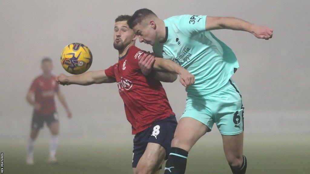 York's Olly Dyson is challenged by Wigan Athletic's Charlie Hughes