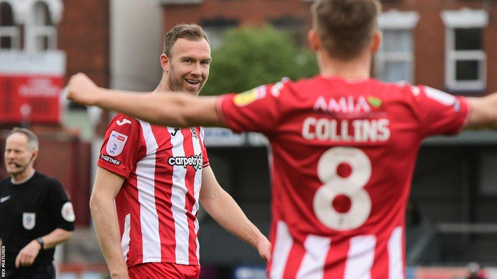 Exeter celebrate a goal by Kevin McDonald