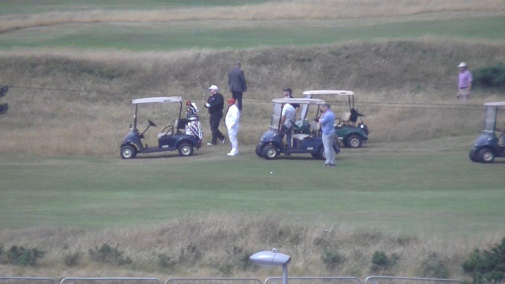 Trump practices his golf swing