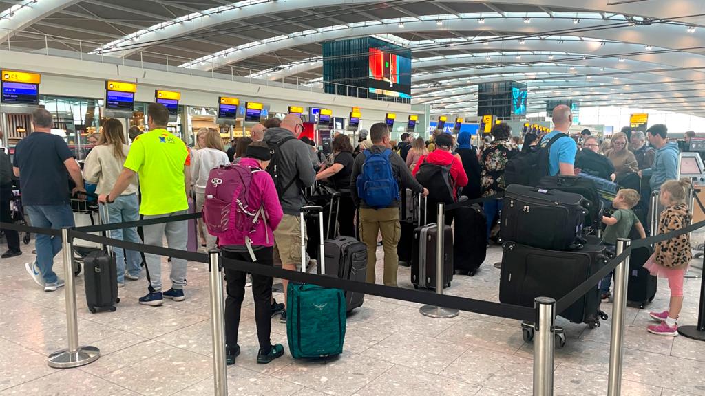 Queues of holiday makers at Heathrow Airport