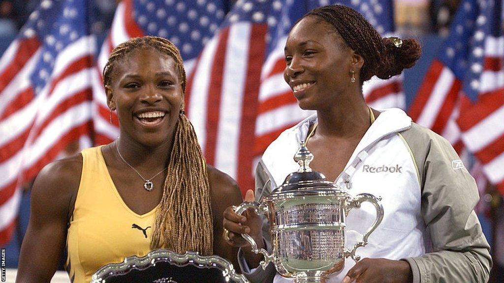 Serena Williams and Venus Williams pose with their trophies after the 2001 US Open women's singles title