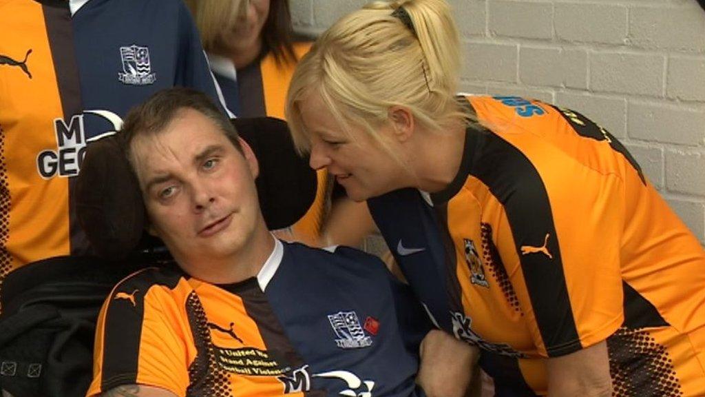 Simon Dobbin and his wife Nicole pitchside at a Cambridge United and Southend United match.