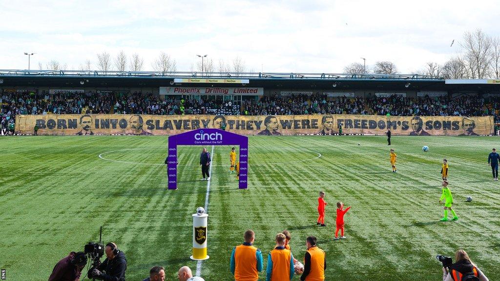 Celtic fans display a banner before kick-off