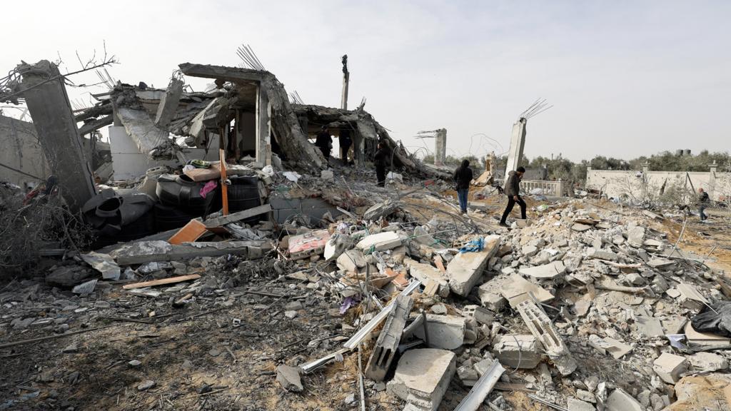 Palestinians inspect the site of an Israeli strike on a house, in Rafah, in the southern Gaza Strip