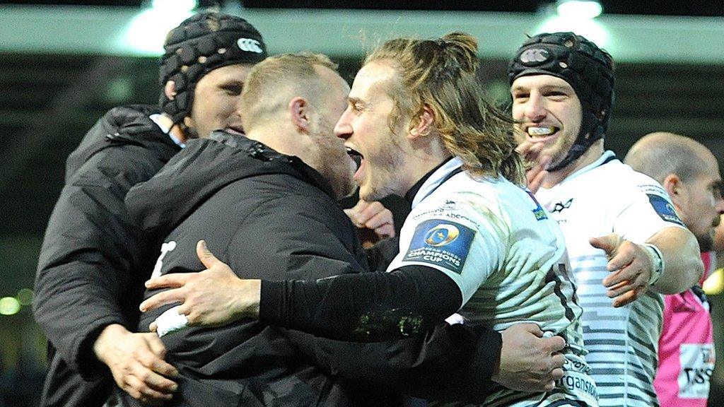 Ospreys try scorer Jeff Hassler celebrates with the substitutes after scoring one of his tries against Northampton