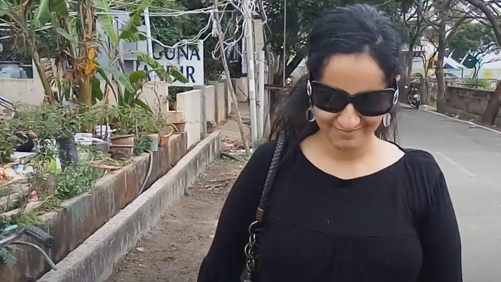 Poonam walking on a street in Bangalore