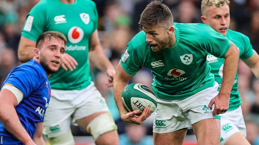 Fly-half Ross Byrne carries the ball for Ireland against France