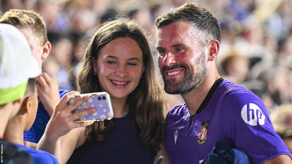 Wrexham keeper Ben Foster poses for a selfie with a fan during the pre-season friendly with Chelsea in North Carolina