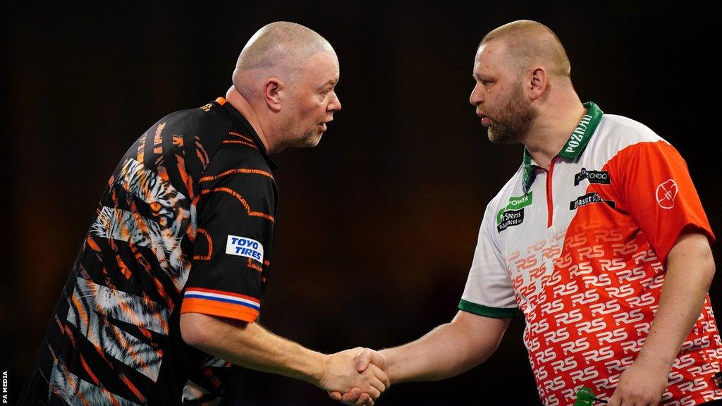 Raymond van Barneveld shakes hands with Radek Szaganski in their PDC World Darts Championship match on Friday