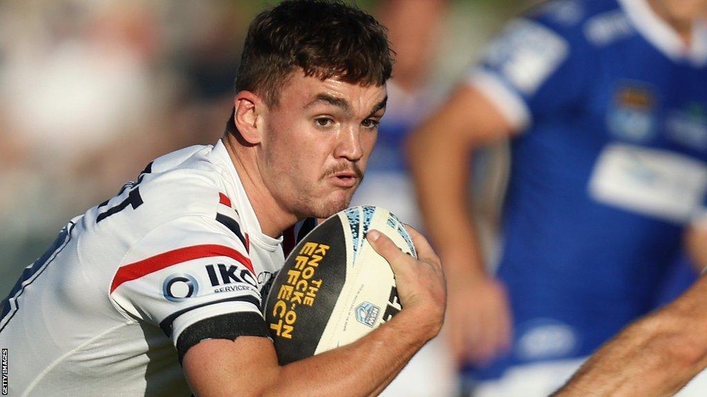 Thomas Deakin takes on a Newtown Jets defender with Sydney Roosters