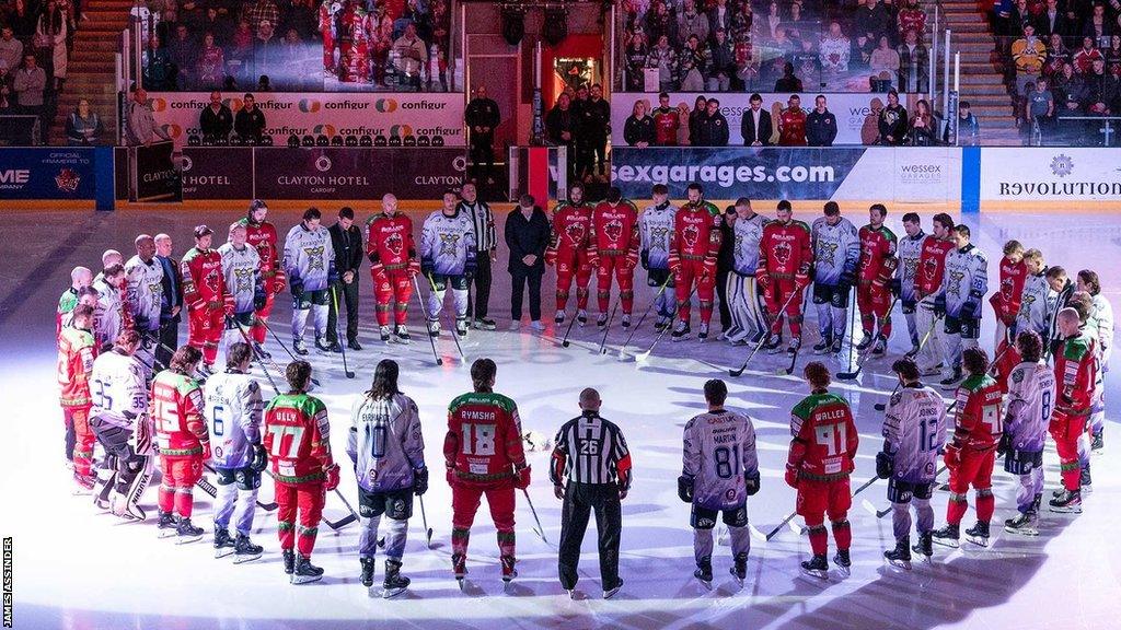 Cardiff Devils and Manchester Storm players join a minutes silence for Adam Johnson