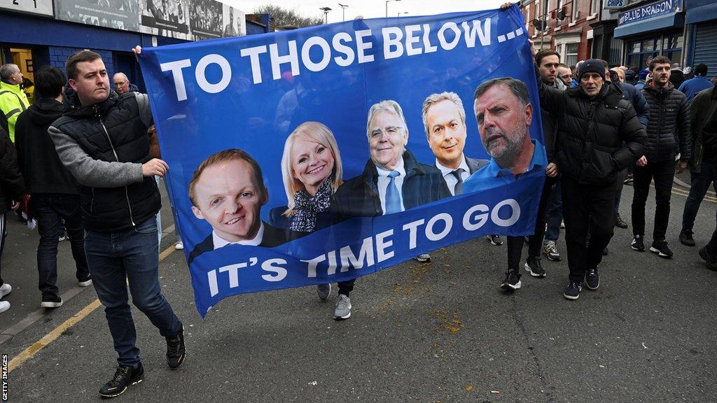 Everton fans hold a banner with portraits of owner Farhad Moshiri (second right) and board members (from left) Grant Ingles, Denise Barrett-Baxendale, Bill Kenwright and Graeme Sharp during a protest