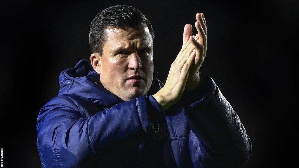 Exeter City manager Gary Caldwell claps