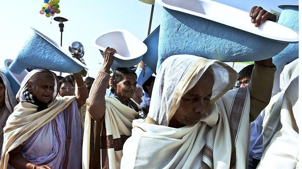 Women carry porcelain toilet seats on the occasion of World Toilet day in 2014 in India.