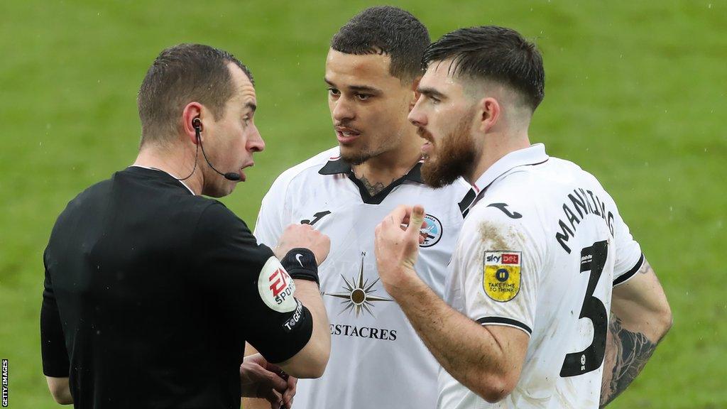 Joel Latibeaudiere and Ryan Manning in action for Swansea