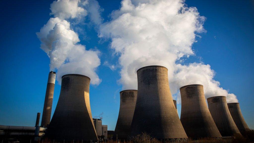 Smoke and steam bellows from the chimneys and cooling towers of Ratcliffe-on-Soar coal fired power station.