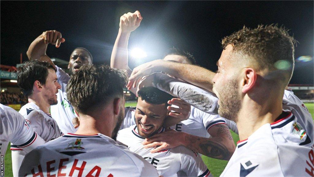 Bolton players celebrate reaching the Papa Johns Trophy final