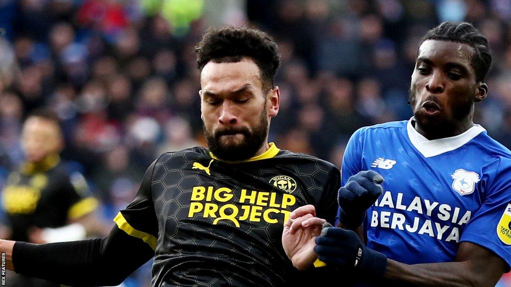 Steven Caulker (left) played all 90 minutes during his Wigan Athletic debut in their 1-1 Championship draw with Cardiff City on Saturday