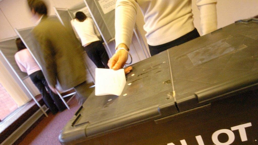 Polling station with voting booths and ballot box