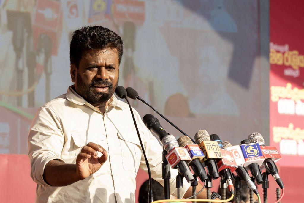 Anura Kumara Dissanayake speaks into an array of microphones