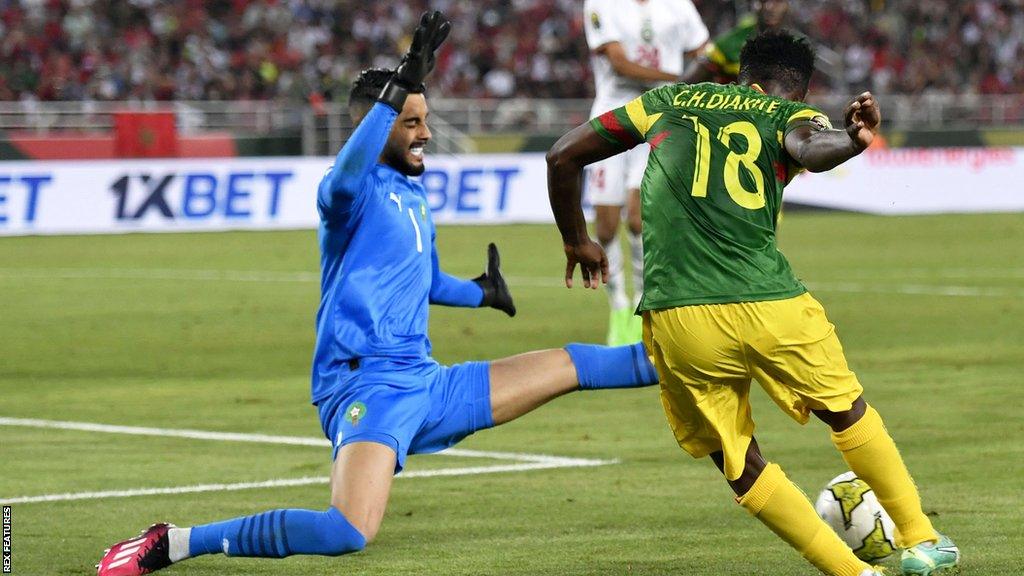 Mali's Cheickna Diakite shoots against Morocco goalkeeper Alaa Bellaarouch in a 2-2 draw at Afcon U23