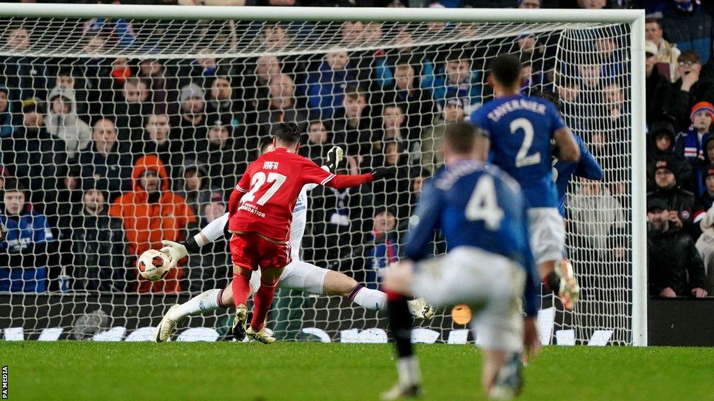 Benfica's Rafa Silva scores the opening goal during the UEFA Europa League Round of 16, second leg match at the Ibrox Stadium, Glasgow.