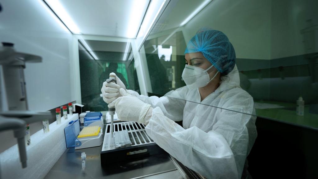 A scientist with test tubes