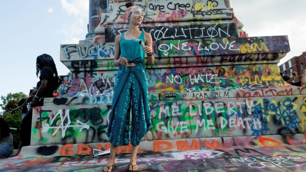 Graffiti covers a confederate statue