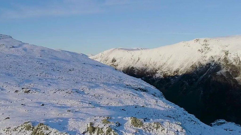 This footage from a drone shows heavy snowfall in the Lake District.