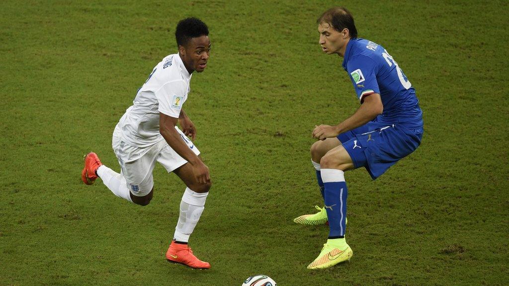 Sterling (left) at the 2014 World Cup, playing in England's match against Italy