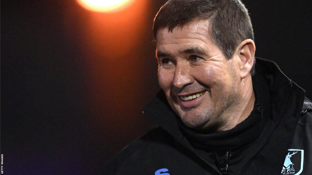 Mansfield boss Nigel Clough smiles on the sideline