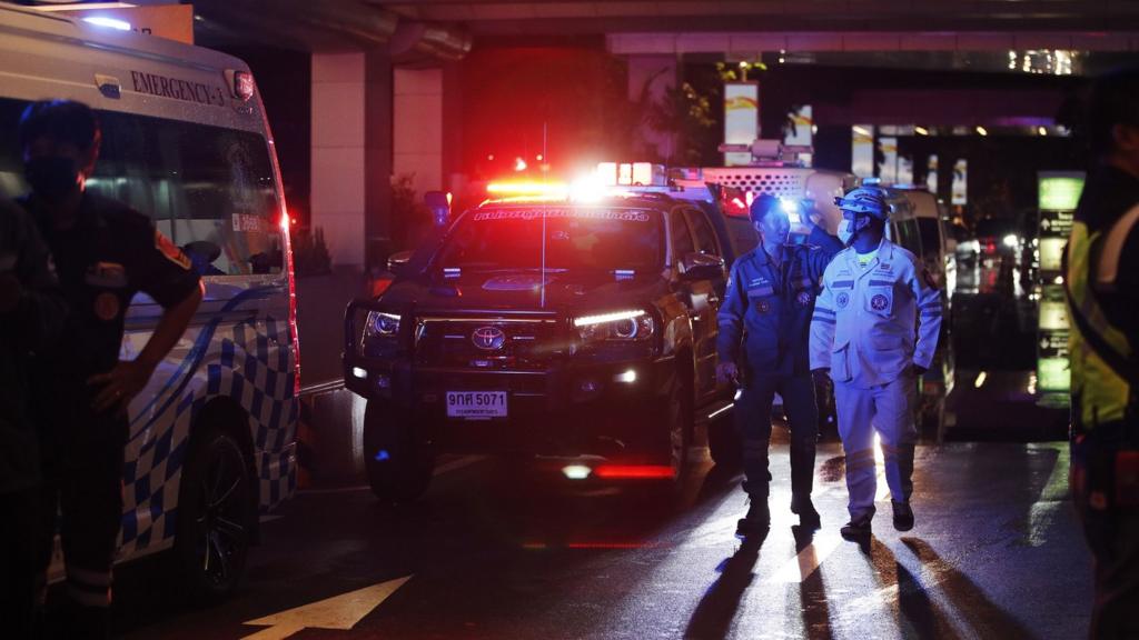 Rescue service personnel walk outside Siam Paragon Mall following gunshots in Bangkok, Thailand, 03 October 2023