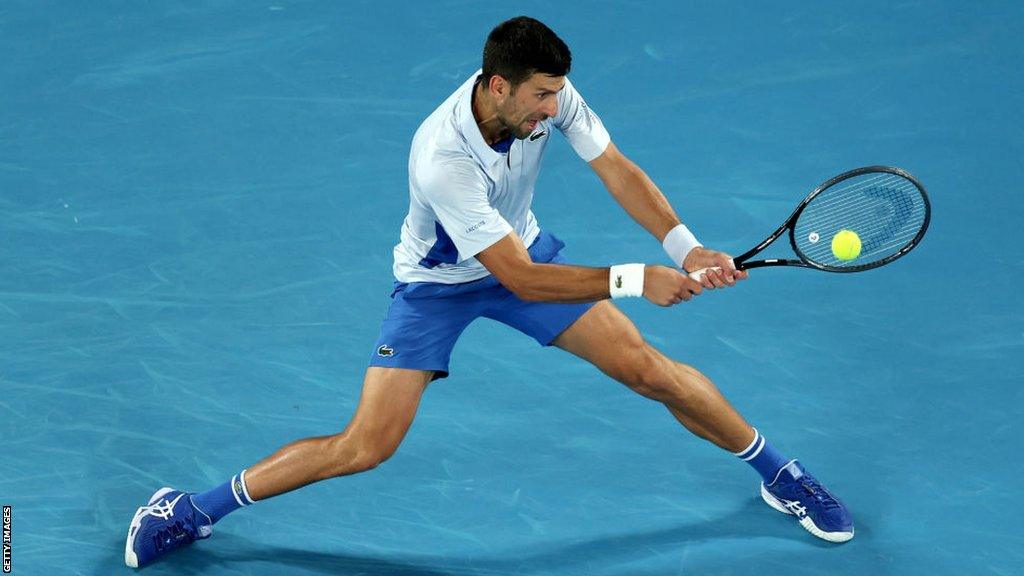 Novak Djokovic clenches his fist in celebration.