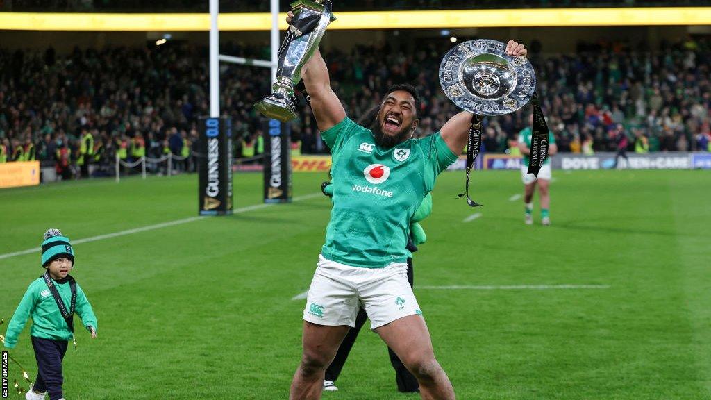 Ireland centre Bundee Aki celebrates Ireland's Grand Slam win over England in March 2023