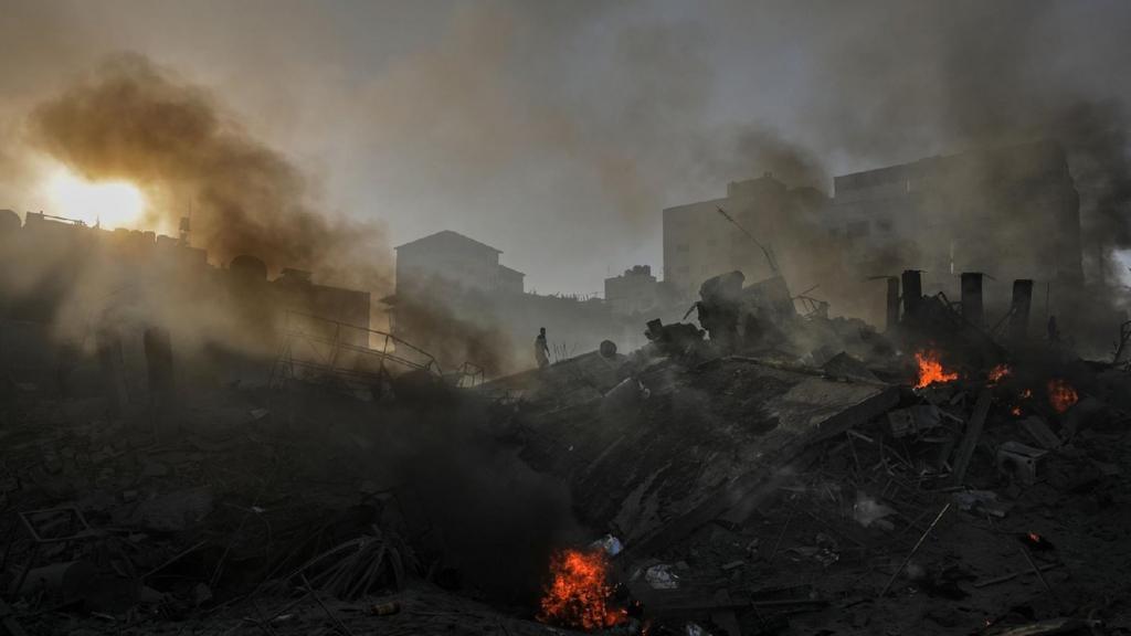 Smoke rises from the rubble of a destroyed area following Israeli air strikes in Gaza City, 25 October 2023. More than 5,500 Palestinians and over 1,400 Israelis have been killed, according to the Israel Defense Forces (IDF) and the Palestinian health authority, since Hamas militants launched an attack against Israel from the Gaza Strip on 07 October, and the Israeli operations in Gaza and the West Bank that followed it.