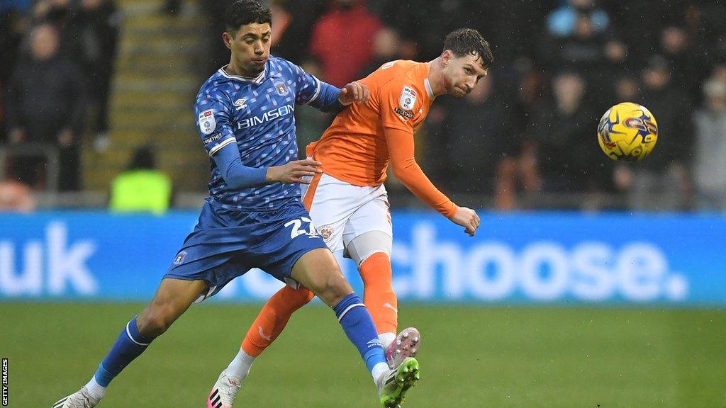 Blackpool's James Husband battles with Carlisle United's Luke Plange during the League One match between Blackpool and Carlisle