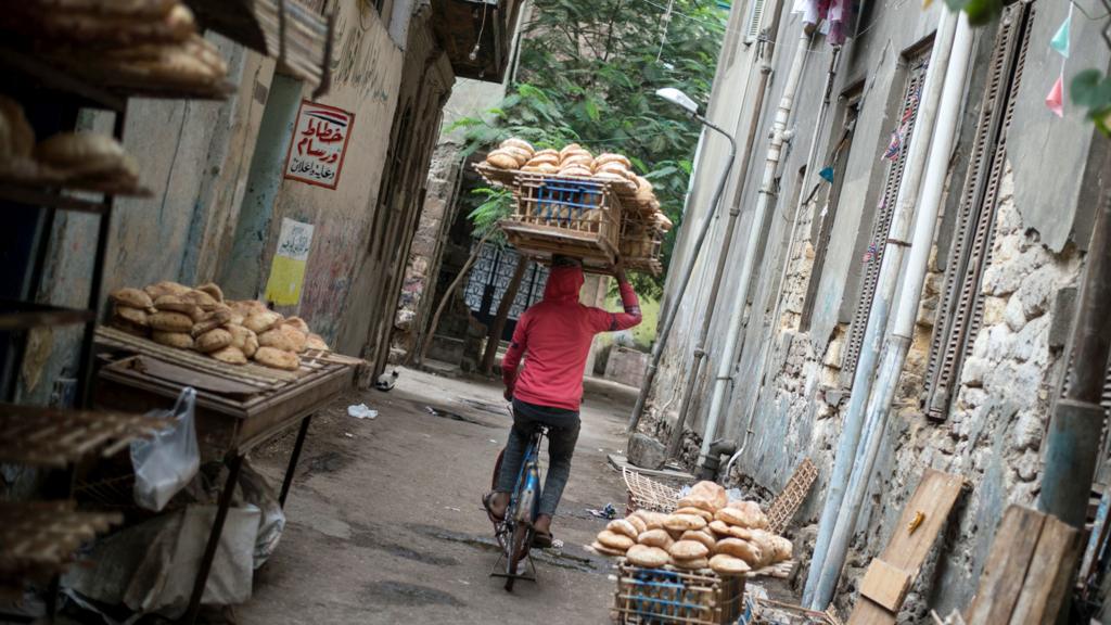 An Egyptian man carries a wood rack full of bread near a traditional bakery in Cairo, Egypt, 22 November 2017