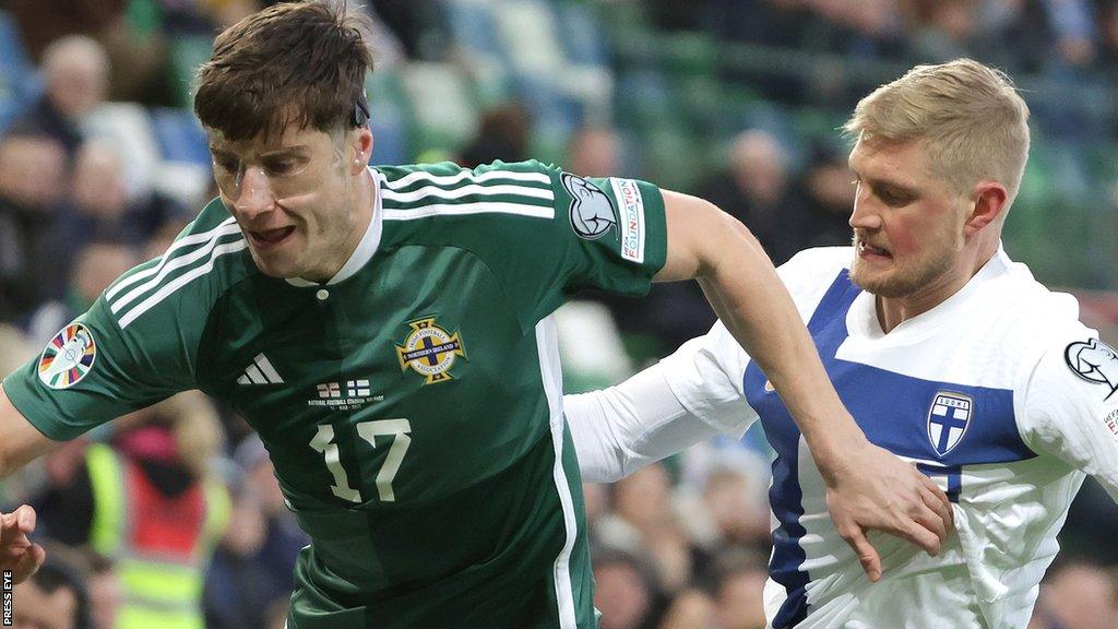 Paddy McNair defends for Northern Ireland against Finland