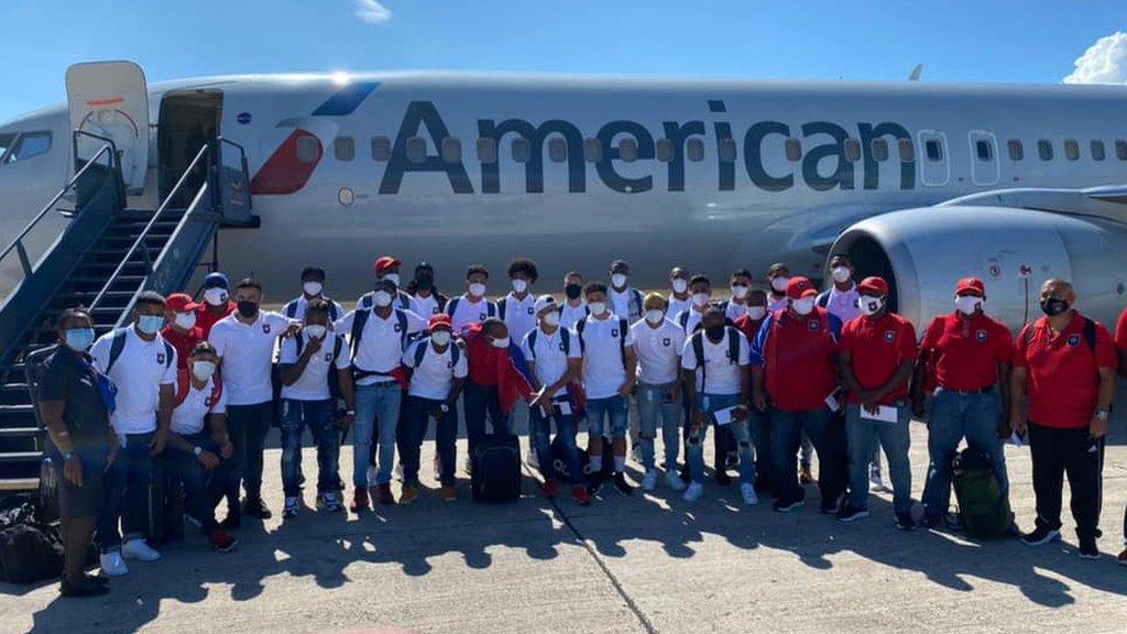 The Belize team posing outside an airplane before flying to Haiti