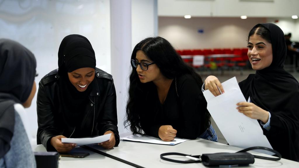 Students react as they check their A-Level results at Ark Academy in London